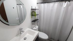 a white bathroom with a sink and a mirror at La Pastora in Monterrey +17 photos