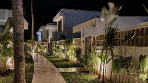 a pathway in front of a house at night at Oasis Dune Villas Lombok in Kuta Lombok