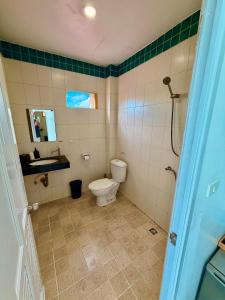 a bathroom with a toilet and a sink at Drift Inn Kata Beach, Guest House in Kata Beach