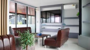 a living room with two chairs and a table at Cabanaz Pool Villa in Ban Zong Katiam