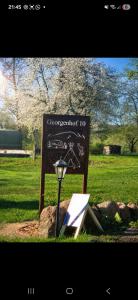 a sign in the grass with a light next to it at Stellplatz für VAN & Wohnmobile in Carpin +2 photos
