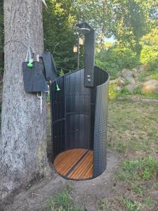 a black bird cage hanging from a tree at Stellplatz für VAN & Wohnmobile in Carpin