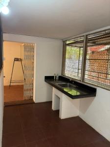 a kitchen with a sink in a room with a window at 3bhk villa in Lalbagh in Mangalore