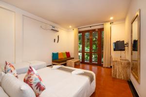 a hotel room with two beds and a television at Wasala Banquets & Nature Resort in Radawana