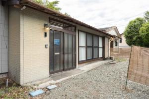 a brick building with a door on the side of it at Shima Yadori Nagomi in Oshima