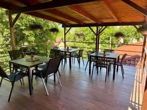 a group of tables and chairs on a patio at Апартаменти Фігля з видом на гори in Mukacheve