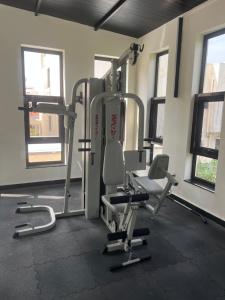a gym with several tread machines in a room at VVR villa in Tirupporūr