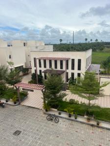 a large white building with trees in front of it at VVR villa in Tirupporūr