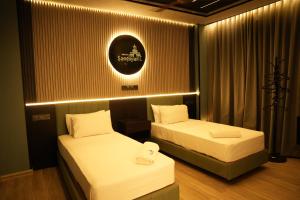 two beds in a room with at Hotel Sangiliyan in Jaffna +17 photos