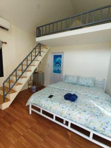 a bedroom with a bed and a bunk ladder at บ้านนอร์ดิก เฮาส์ เขาค้อ in Khao Kho