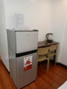 a refrigerator and a table in a room at TDGuestRoom Siargao in Dapa +9 photos