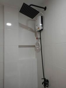 a shower with a hair dryer in a bathroom at TDGuestRoom Siargao in Dapa
