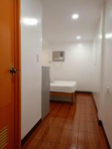 a hallway with a bench in a white room at TDGuestRoom Siargao in Dapa