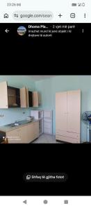 a picture of a kitchen with white cabinets at Vila Gega in Tale
