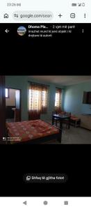 a picture of a bedroom with a bed and a table at Vila Gega in Tale