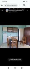 a picture of a kitchen with a table and chairs at Vila Gega in Tale
