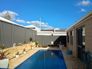 a swimming pool in the backyard of a house at Eden beach retreat in Jindalee