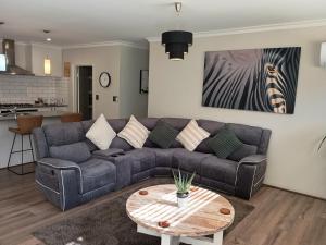 a living room with a couch and a table at Eden beach retreat in Jindalee