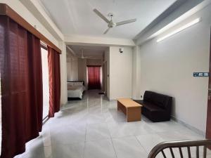 a living room with a couch and a bed at Best Eastern Suite in Dhaka