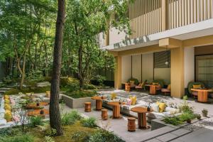a courtyard with tables and chairs in a building at Six Senses Kyoto in Kyoto
