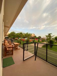 a balcony with a table and chairs and a view at La ferme labyed in Fez