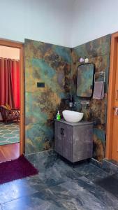 a bathroom with a sink and a mirror at Falak Stays in Shamshi