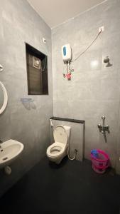 a bathroom with a toilet and a sink at VVR villa in Tirupporūr