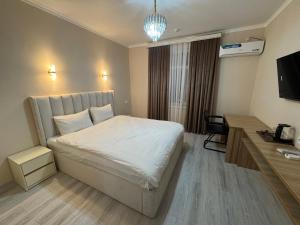 a hotel room with a bed and a desk at ALAmir Khiva in Khiva