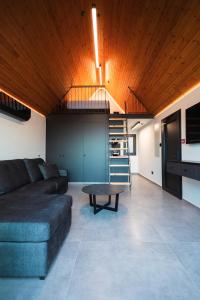 a living room with a couch and a table at NOE Suites in Ayios Theodhoros