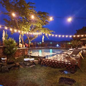 a swimming pool at night with lights on it at Nobless Pension in Taean
