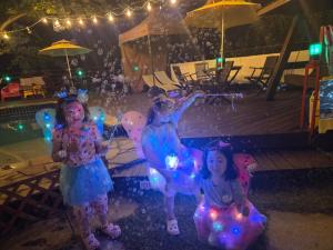 two little girls are standing next to a pool with balloons at Nobless Pension in Taean +57 photos