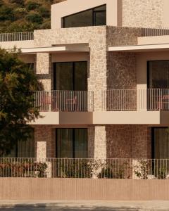 a building with balconies on the side of it at Petra Mare Villas in Psathopyrgos