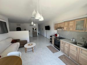 a kitchen and living room with a couch and a table at Costelia Studio in Ialysos +8 photos