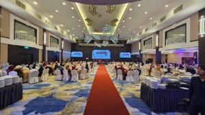 a large group of people sitting in a room with a red carpet at Lotus Desaru Beach Resort & Spa in Desaru +177 photos