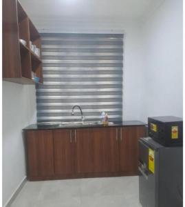 a kitchen with a sink and a counter top at Meg place in Amamoli
