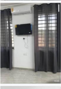a room with a wall with a tv on the wall at Meg place in Amamoli