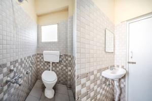 a bathroom with a toilet and a sink at Collection O Kadugodi Tree Park Metro Station Bengaluru Formerly Royal Rooms in Bangalore +28 photos