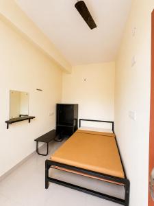 a bedroom with a bed in a room at SLV Comforts in Chikmagalūr +15 photos