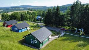 an aerial view of a village with houses and a playground at Domki Pod Sudeckim Niebem in Duszniki Zdrój