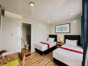 a hotel room with two beds and a bathroom at Bhuana Agung Villa and Restaurant in Jatiluwih +110 photos