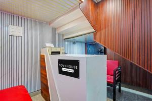 a room with a counter with a two universe sign on it at Townhouse Vikas Nagar Lucknow Formerly Wave BLU in Lucknow