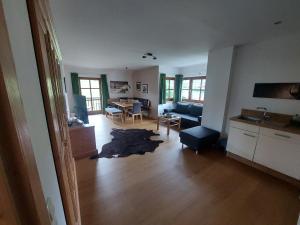 a living room with a couch and a table at Alpen Appartements in Embach