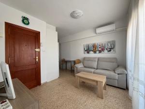 a living room with a couch and a table at NEW UDYNO in Piles