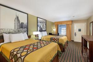 a hotel room with two beds and a window at Super 8 by Wyndham Nashville West in Nashville
