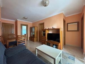 a living room with a couch and a table at Voramar VI in Piles