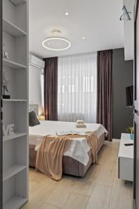 a bedroom with a bed and a large window at Apartment in MoonLight Residence in Mamaia