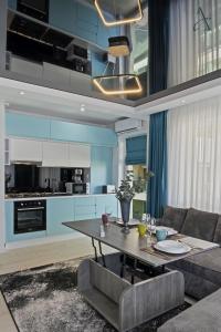 a living room with a table and a couch at Apartment in MoonLight Residence in Mamaia