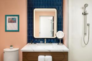 a bathroom with a sink and a mirror at Hyatt Centric San Juan Isla Verde in San Juan