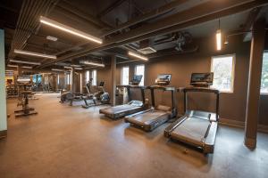 a gym with a row of treadmills and machines at Hyatt Centric San Juan Isla Verde in San Juan