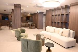 a living room with a white couch and chairs at Ramada by Wyndham Duzce in Duzce